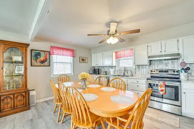 a kitchen with a table and chairs and a ceiling fan at Welcoming Kentucky Home with Sprawling Views! in Corinth