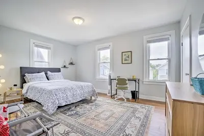 a bedroom with a bed and a desk and windows at Convenient Columbus Retreat, 2 Mi to Downtown in Columbus