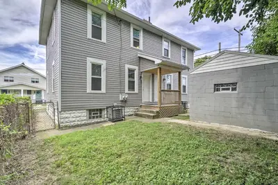 a gray house with a fence and a yard at Convenient Columbus Retreat, 2 Mi to Downtown in Columbus