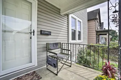 a chair sitting on the front porch of a house at Convenient Columbus Retreat, 2 Mi to Downtown in Columbus