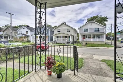 a porch with a gate with flowers and houses at Convenient Columbus Retreat, 2 Mi to Downtown in Columbus