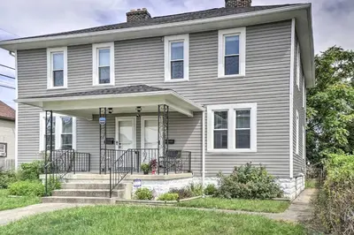 a gray house with a front porch and grass at Convenient Columbus Retreat, 2 Mi to Downtown in Columbus