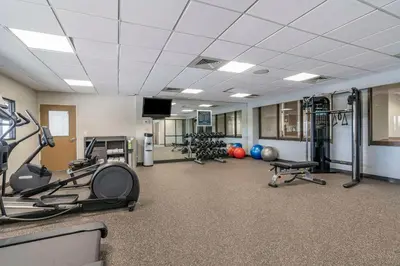 a gym with several treadmills and exercise machines at MainStay Suites Lexington I-75 in Lexington