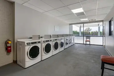 a laundry room with four washing machines in it at MainStay Suites Lexington I-75 in Lexington