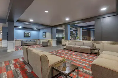 a lobby with a waiting room with couches and chairs at MainStay Suites Lexington I-75 in Lexington