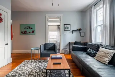 a living room with a couch and a table at Historic Comfy German Village Haus sleeps6petsOK in Columbus