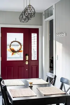 a dining room with a red door and a table with chairs at Historic Comfy German Village Haus sleeps6petsOK in Columbus