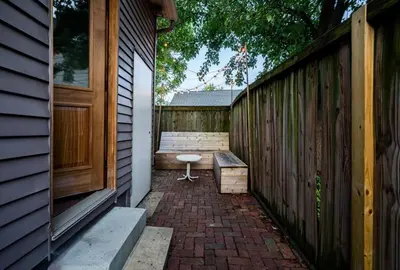 a porch with a bench next to a fence at Historic Comfy German Village Haus sleeps6petsOK in Columbus