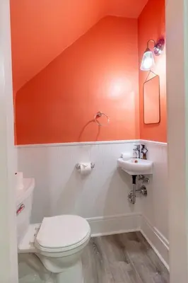 an orange bathroom with a toilet and a sink at Walkable And Cozy German Village Hauspets Ok in Columbus