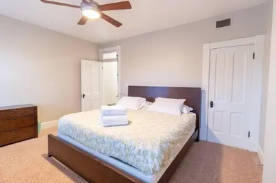 a bedroom with a bed with a ceiling fan at Walkable And Cozy German Village Hauspets Ok in Columbus