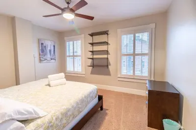 a bedroom with a bed and a ceiling fan at Walkable And Cozy German Village Hauspets Ok in Columbus