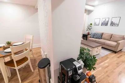 a living room with a couch and a table at Spacious 1 bed 1 bath Downtown OTR condo minutes walk to the Reds Bengals stadium & more! in Cincinnati