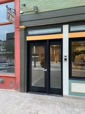 a store with doors on the side of a street at Spacious 1 bed 1 bath Downtown OTR condo minutes walk to the Reds Bengals stadium & more! in Cincinnati