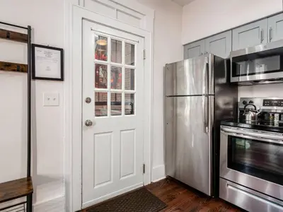a kitchen with a refrigerator and a microwave at Cute German Village LilHausCity ParkPetsOK in Columbus
