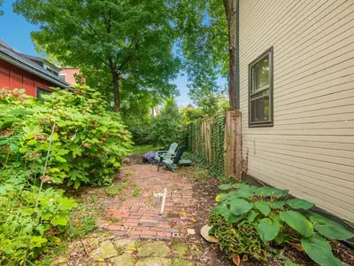 a patio with a bench next to a house at Cute German Village LilHausCity ParkPetsOK in Columbus