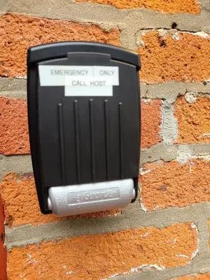 an emergency call box on a brick wall at Cute German Village LilHausCity ParkPetsOK in Columbus