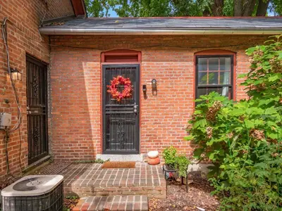 a brick house with a door with a wreath on it at Cute German Village LilHausCity ParkPetsOK in Columbus