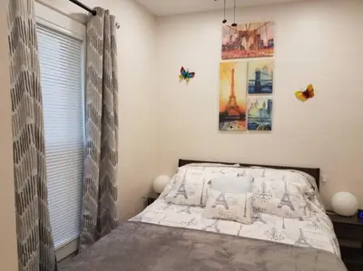 a bedroom with a bed and a window with butterflies at Super Close to Hot Spots in Ohio City, Cleveland in Cleveland