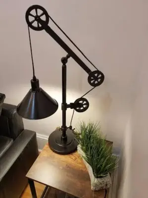 a black lamp on a wooden table next to a couch at Super Close to Hot Spots in Ohio City, Cleveland in Cleveland