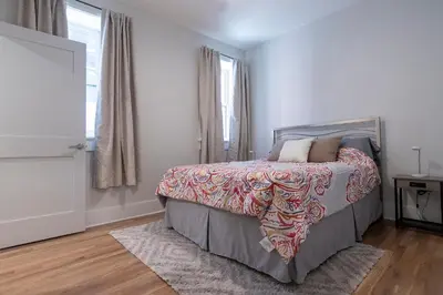 a bedroom with a bed and a window at Spacious 2 bed 2 bath Downtown OTR condo minutes walk to the Reds Bengals stadium & more! in Cincinnati
