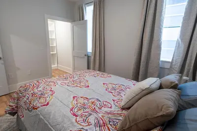 a bedroom with a bed with a colorful blanket at Spacious 2 bed 2 bath Downtown OTR condo minutes walk to the Reds Bengals stadium & more! in Cincinnati