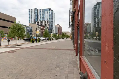 an empty street in a city with tall buildings at Spacious 2 bed 2 bath Downtown OTR condo minutes walk to the Reds Bengals stadium & more! in Cincinnati