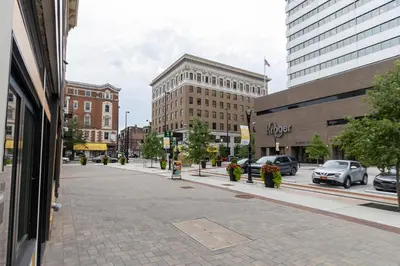 a city street with cars parked on the street at Spacious 2 bed 2 bath Downtown OTR condo minutes walk to the Reds Bengals stadium & more! in Cincinnati