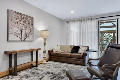a living room with a couch and a chair at Magnolia Suite - Main Street Lodge in Berlin in Berlin