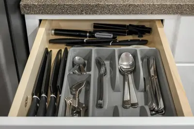 a kitchen sink with utensils in a drawer at Magnolia Suite - Main Street Lodge in Berlin in Berlin