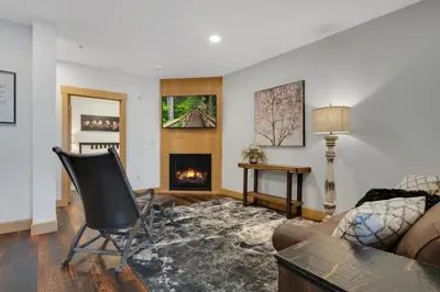 a living room with a chair and a fireplace at Magnolia Suite - Main Street Lodge in Berlin in Berlin