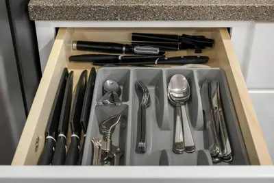 a kitchen sink with utensils in a drawer at Hickory Suite - Main Street Lodge in Berlin in Berlin