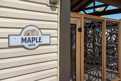 a sign on the side of a building at Maple Suite - Main Street Lodge in Berlin in Berlin