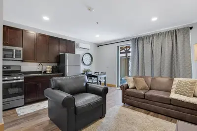 a living room with a couch and a chair at Maple Suite - Main Street Lodge in Berlin in Berlin