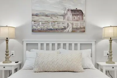 a bedroom with a white bed with two lamps at Sycamore Suite - Main Street Lodge in Berlin in Berlin