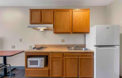 a kitchen with a sink and a white refrigerator at Extended Stay America Select Suites - Cleveland - Airport in Cleveland