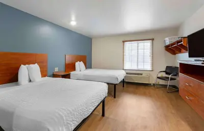 a hotel room with two beds and a kitchen at Extended Stay America Select Suites - Cleveland - Airport in Cleveland
