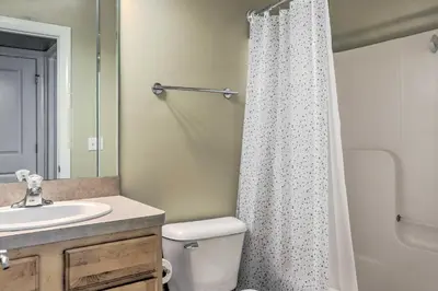 a bathroom with a white shower curtain and a sink at about 2 Mi to Downtown - Cozy Cleveland Unit in Cleveland