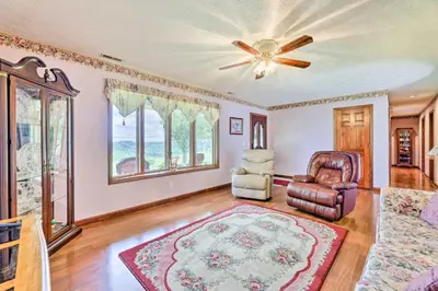 a living room with a ceiling fan and a couch at Charming Williamstown Retreat with Private Yard in Williamstown