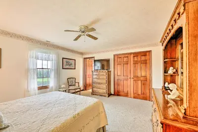 a bedroom with a bed and a ceiling fan at Charming Williamstown Retreat with Private Yard in Williamstown