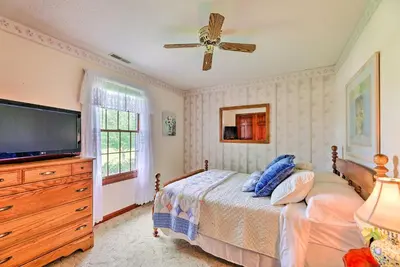 a bedroom with a bed and a flat screen tv at Charming Williamstown Retreat with Private Yard in Williamstown