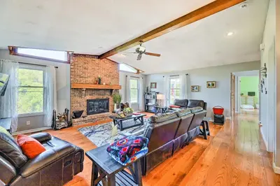 a living room with a couch and a fireplace at Family-Friendly Brookville Home with Hot Tub! in Brookville