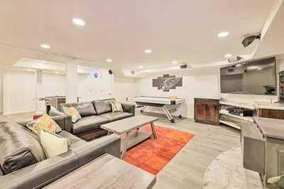 a living room with a couch and a pool table at Family-Friendly Brookville Home with Hot Tub! in Brookville