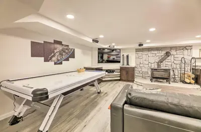 a living room with a pool table and a kitchen at Family-Friendly Brookville Home with Hot Tub! in Brookville