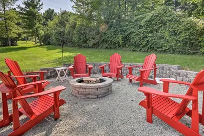 a group of red chairs around a fire pit at Family-Friendly Brookville Home with Hot Tub! in Brookville