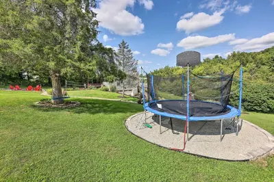 a trampoline in the grass in a park at Family-Friendly Brookville Home with Hot Tub! in Brookville