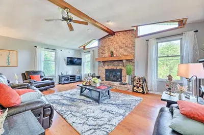 a living room with a couch and a fireplace at Family-Friendly Brookville Home with Hot Tub! in Brookville