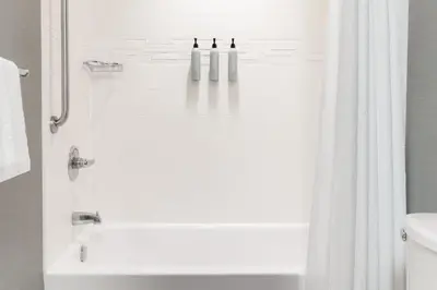 a bathroom with a shower with a white shower curtain at Residence Inn by Marriott Youngstown Warren/Niles in Niles