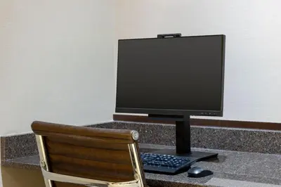 a computer monitor sitting on a desk with a chair at Residence Inn by Marriott Youngstown Warren/Niles in Niles