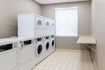 a laundry room with washing machines and a window at Residence Inn by Marriott Youngstown Warren/Niles in Niles