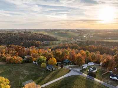 an aerial view of a neighborhood with trees and houses at Maple Leaf Cabin in Millersburg